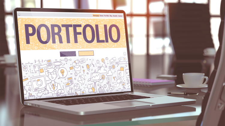 Laptop flipped open with the word "Portfolio" at the top in big block letters.