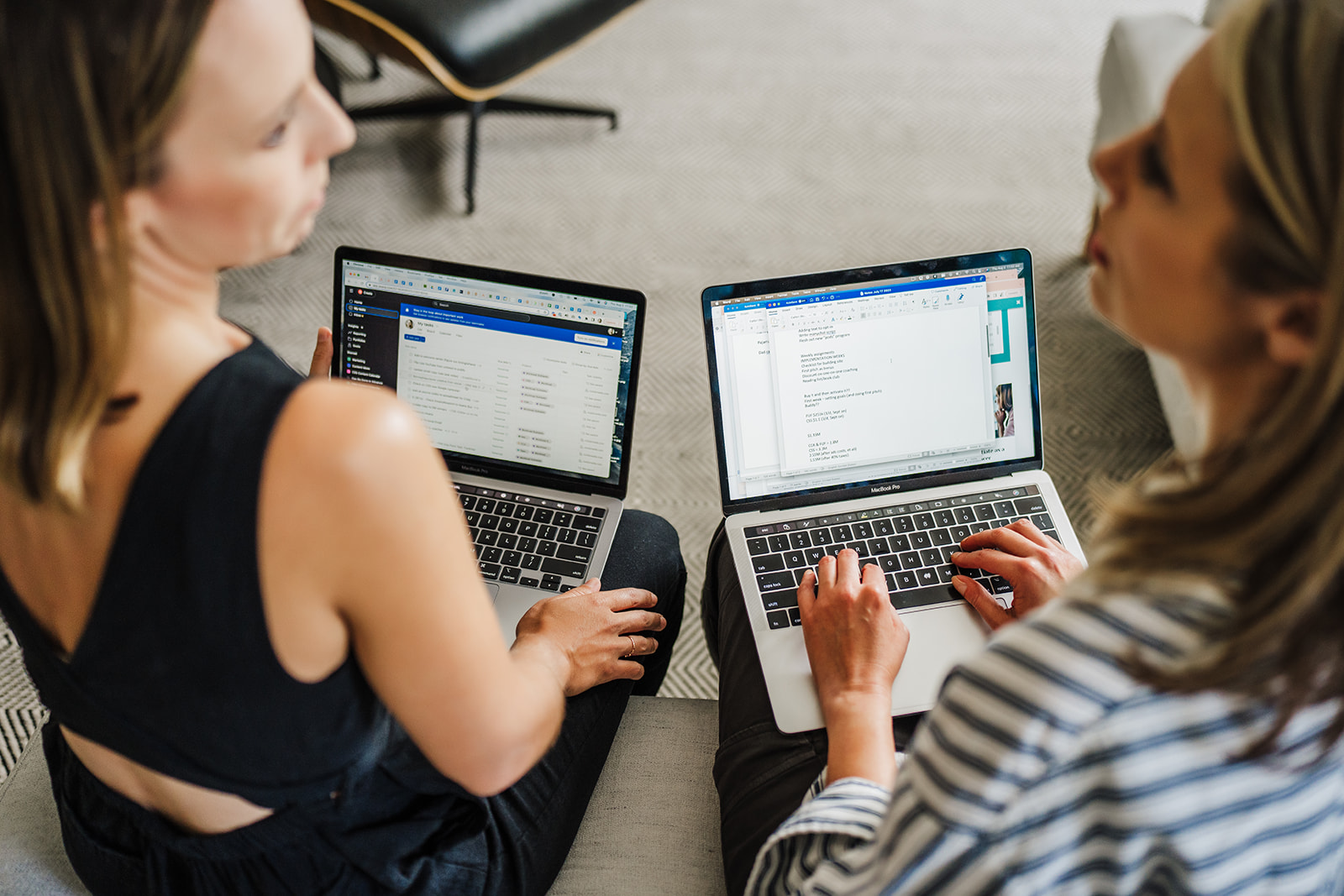 Nicki Krawczyk and Kate Sitarz working on their laptops together