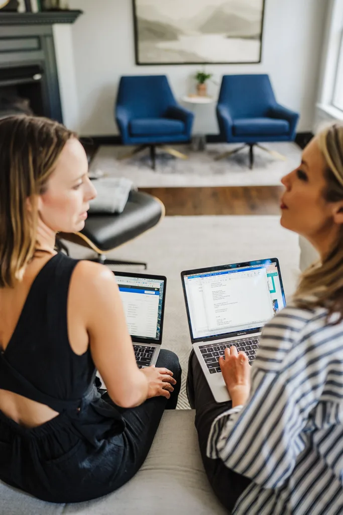 Nicki Krawczyk speaks to her co-host of the Build Your Copywriting Business podcast, Kate Sitarz. They both have laptops on their knees.